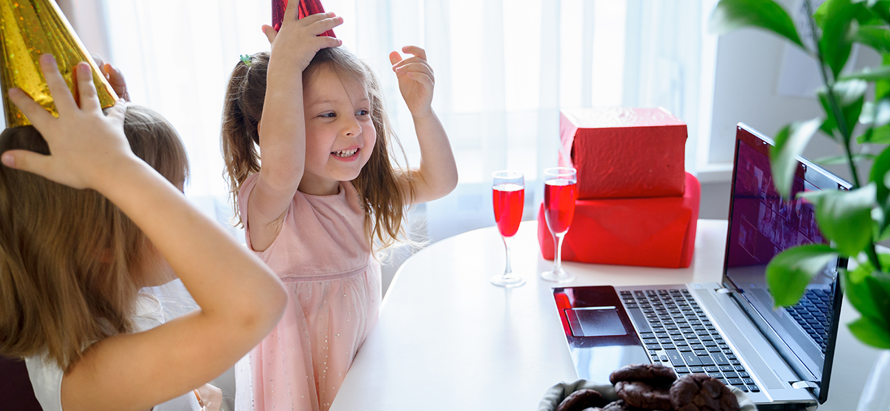 Image: Students at home celebrating a holiday on Zoom surrounded by drinks and snacks.