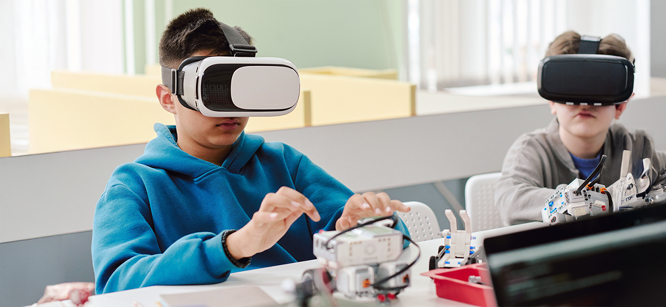 Image: Students in a classroom using augmented reality glasses to work on a project.